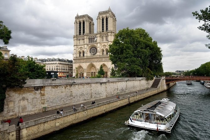Notre-Dame across the Seine with a river cruise boat passing