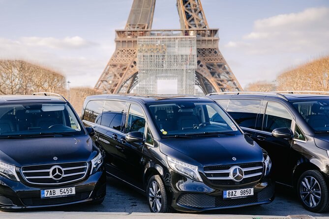 Private tour vehicles lined up in front of the Eiffel Tower